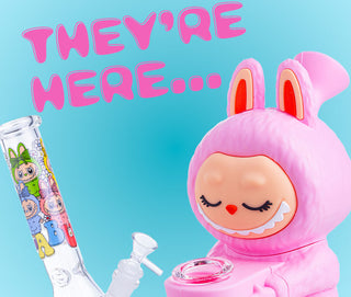 Labubu-style pipe with text 'THEY'RE HERE...' on a blue background